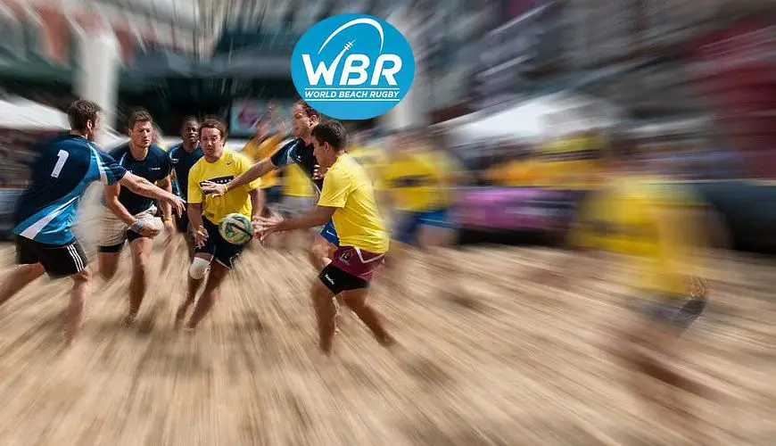 Athletes playing beach rugby in the sand